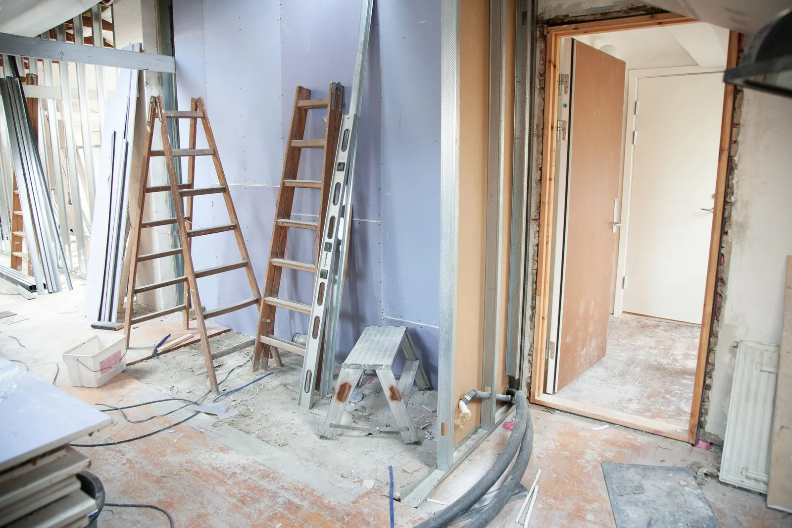 An unfinished commercial space with exposed ceiling and concrete floor